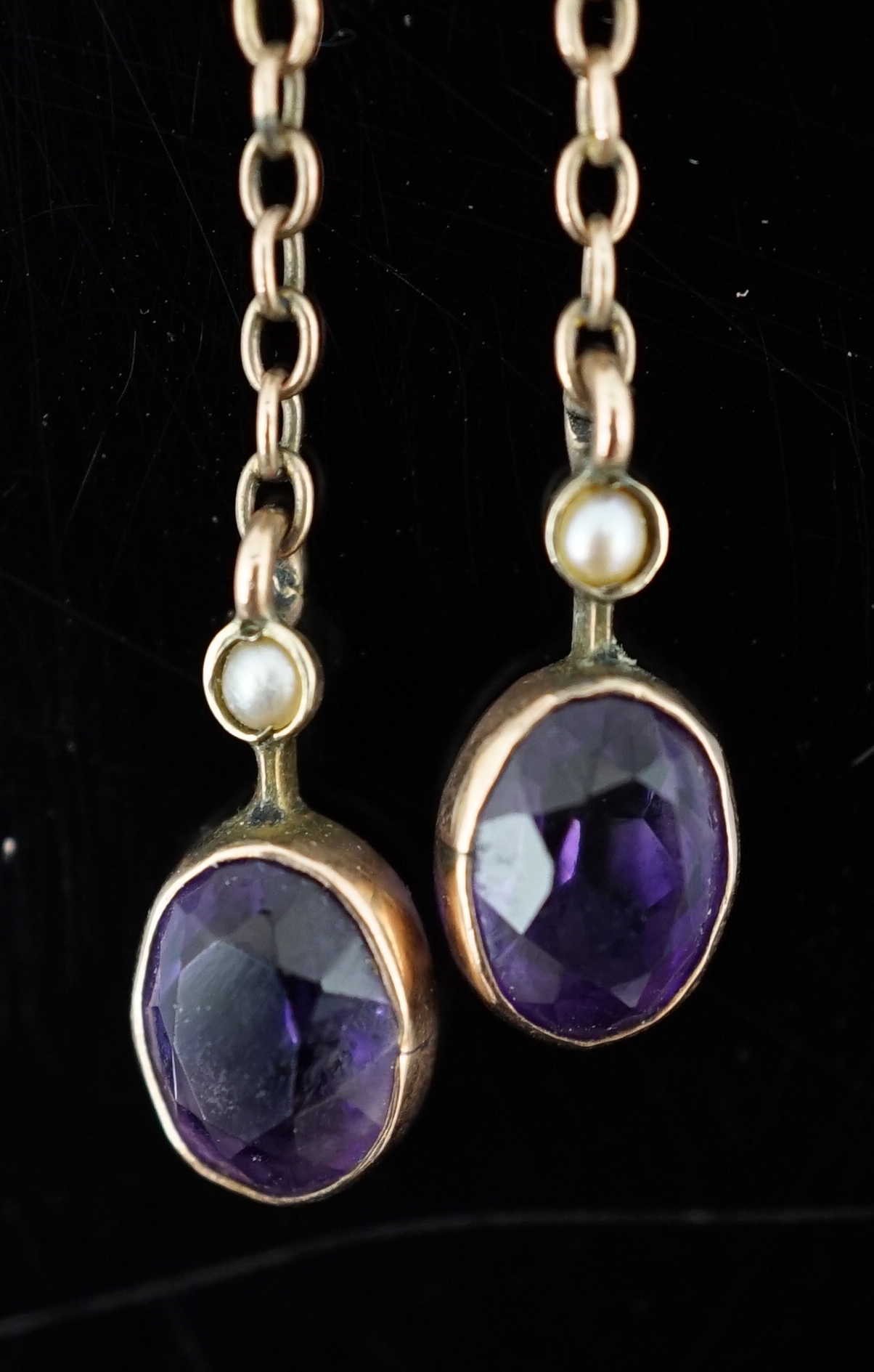 A cased Edwardian 9ct gold, amethyst and seed pearl cluster set double drop pendant necklace